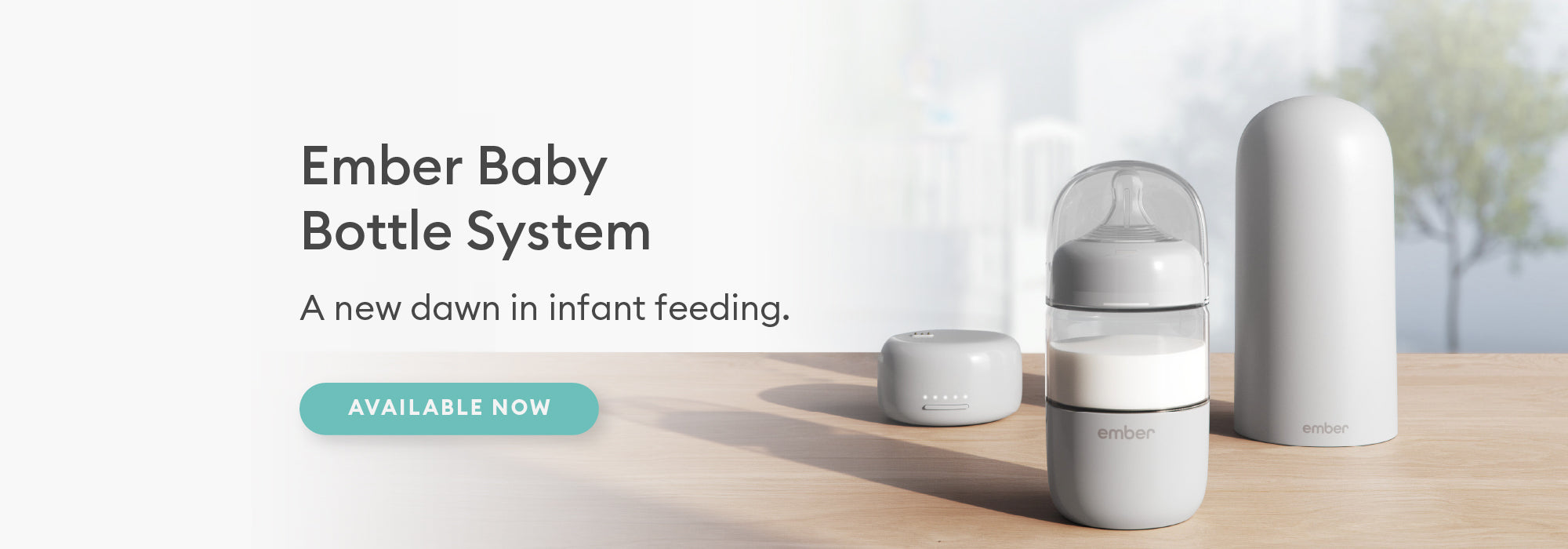The Ember Baby Bottle System rests on a table top in a nursery.