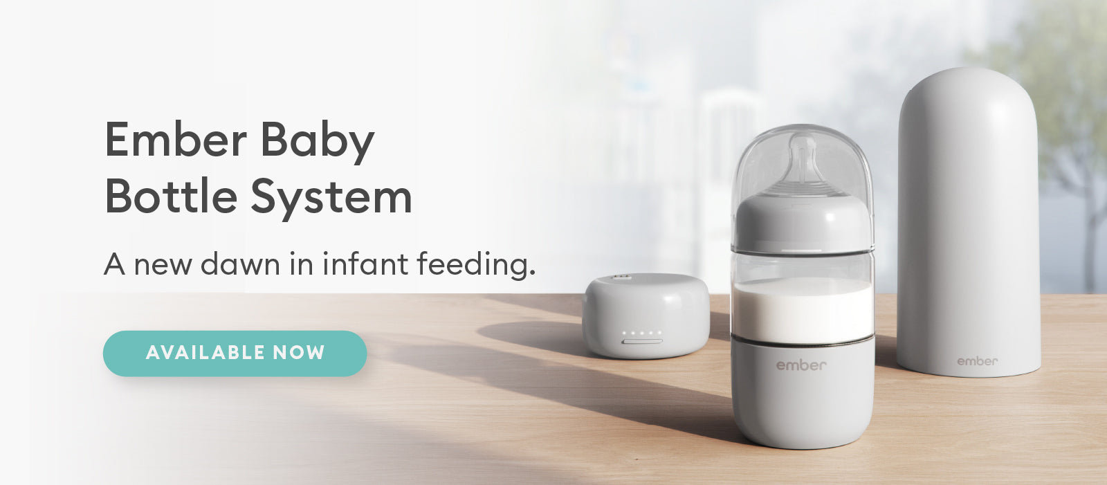 The Ember Baby Bottle System rests on a table top in a nursery.