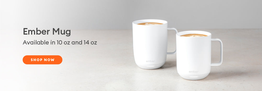 A 10 oz and 14 oz Ember Mug² in White sit next to each other.