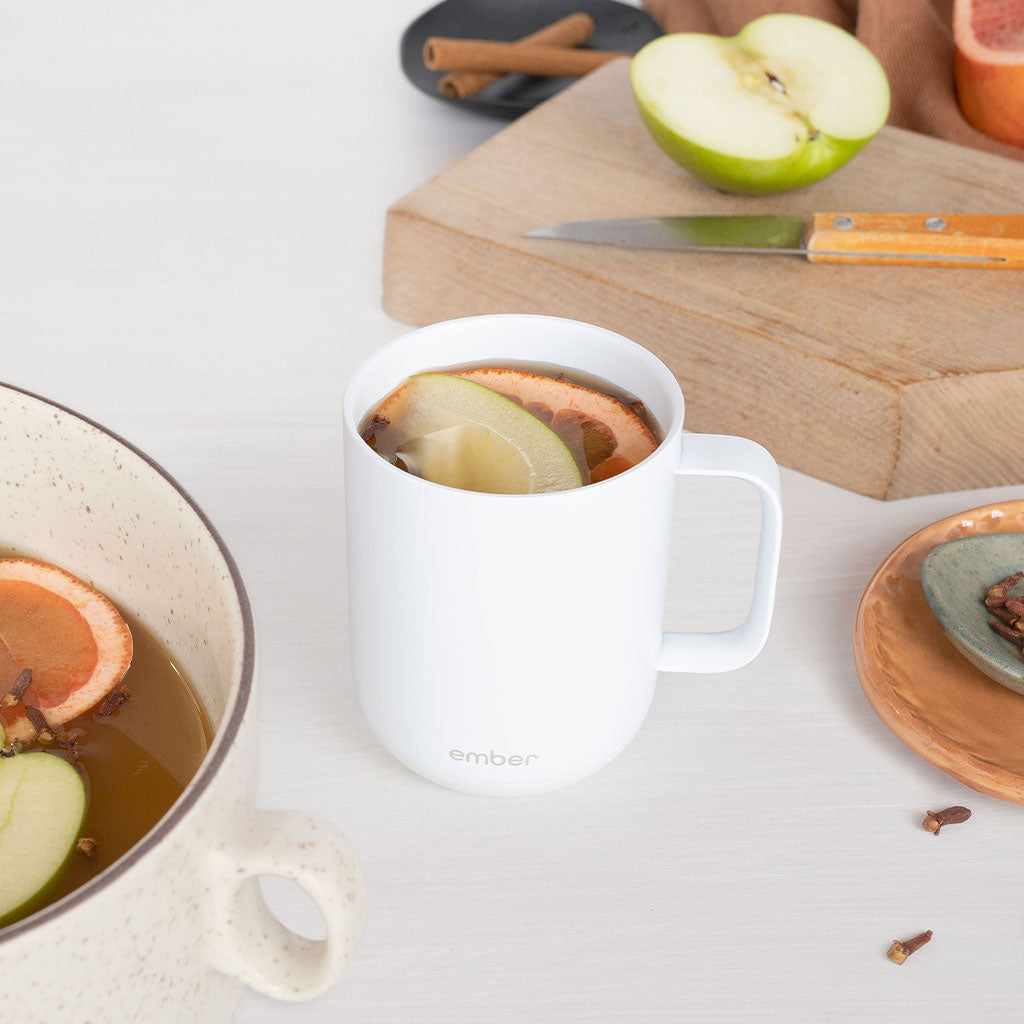 Ember Mug² filled with apple, blood orange slices, and cloves.