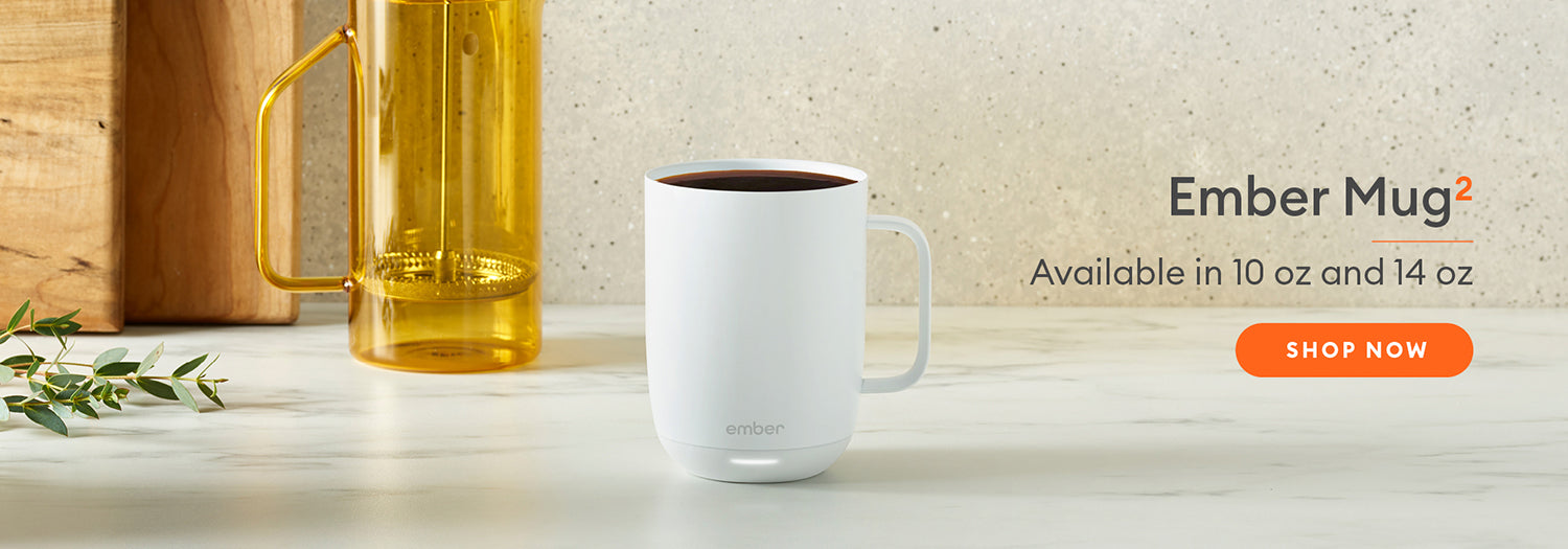 Ember Mug² in white on a marble countertop with a cream speckled wall.